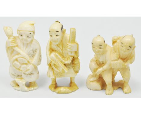 Japanese carved ivory netsuke, probably Mehji, modelled as two standing figures, 6cms and two others, (3).