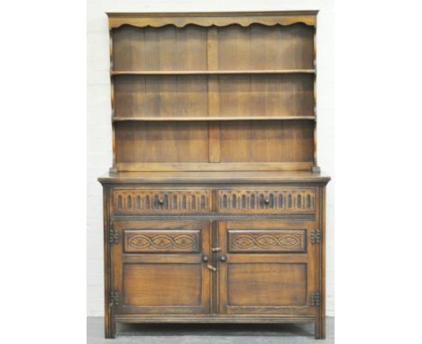 Reproduction oak dresser, with a two shelf delft rack, the base with two drawers and two panelled doors, width 122cms.