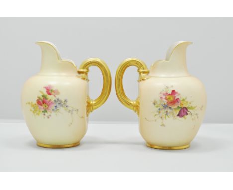 Two Royal  Worcester jugs, circa 1900 and later, each with floral decoration on a blush ground, No. 1094.