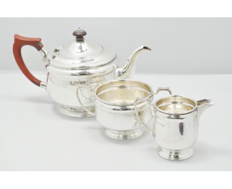 Three-piece silver teaset, by Alexander Clark & Co. Ltd, Birmingham 1938, circular form, the teapot with composition handle a