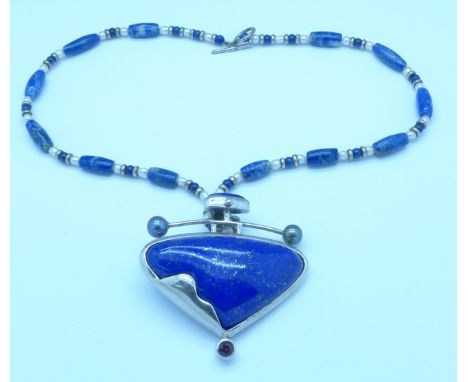 A large silver, blue stone and pearl set necklace