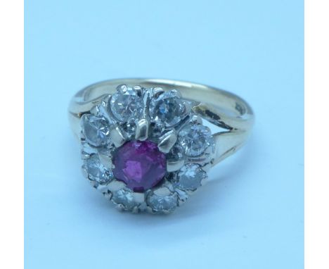 A 9ct gold, ruby and diamond cluster ring, approximately 0.80 carat diamond weight, 5.5g, M