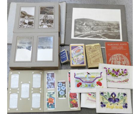An album of early 20th Century photographs, a handbook, Marching Sons and Tommies' Tunes, silk and embroidered postcards, pla