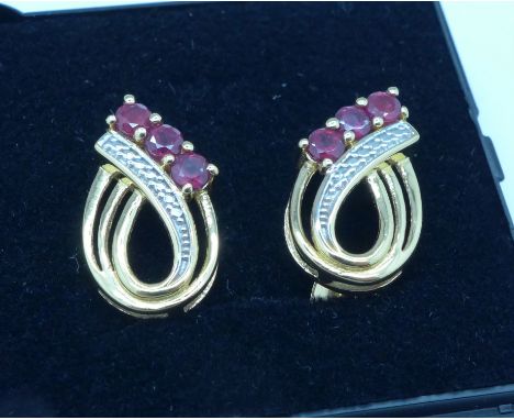 A pair of silver gilt and ruby earrings