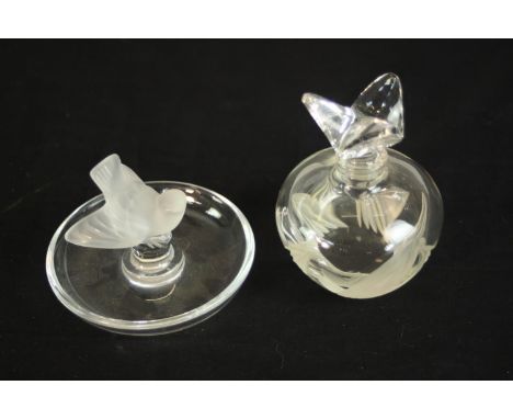 A Lalique pin and ring holder, in the form of a frosted songbird with circular base etched, Lalique France along with another
