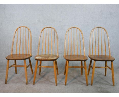 A set of four 20th century Ercol style blond elm hoop back Windsor dining chairs. 