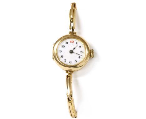 A ladies' 15ct gold mechanical bracelet watch, 26mm diameter, with a white enamel dial, black Arabic numerals with red at '12