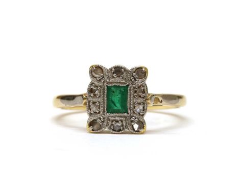 An 18ct gold emerald and diamond cluster ring, with a rectangular step cup emerald, milligrain set, to surround of rose cut d