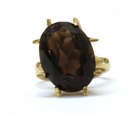 A 9ct gold single stone smoky quartz ring, an oval mixed cut smoky quartz, approximately 18 x 13mm, eight claw set at an angl