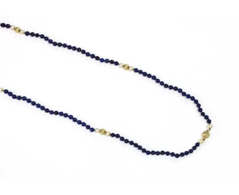 A single row lapis lazuli, cultured pearl and gold bead necklace, with lapis lazuli beads, 6 to 6.5mm in size, strung knotted