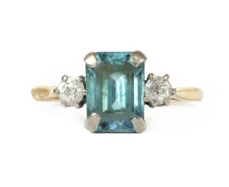 A gold blue zircon and diamond three stone ring, with an emerald cut blue zircon, approximately 9 x 7mm, with an old European