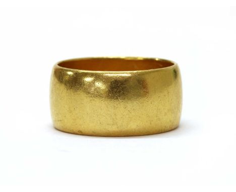 A 22ct gold wedding ring, of light 'D' section, London 1962, 10.5mm wide, 14.80g.Finger size S LECondition report: Minor surf