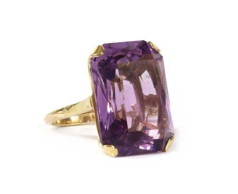 A gold single stone amethyst ring, with an octagonal mixed cut amethyst, approximately 22 x 16 x 10mm, four claw set to open 