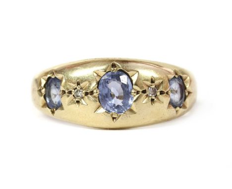 A 9ct gold sapphire and diamond ring, with alternating graduated oval mixed cut sapphires and eight cut diamonds, star set to