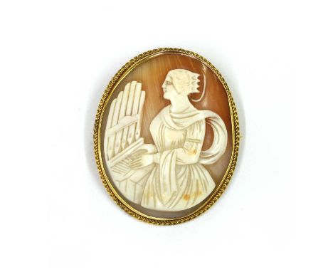 A 9ct gold shell cameo brooch, depicting Saint Cecilia, the patron saint of music and musicians, playing the pipe organ, rub 