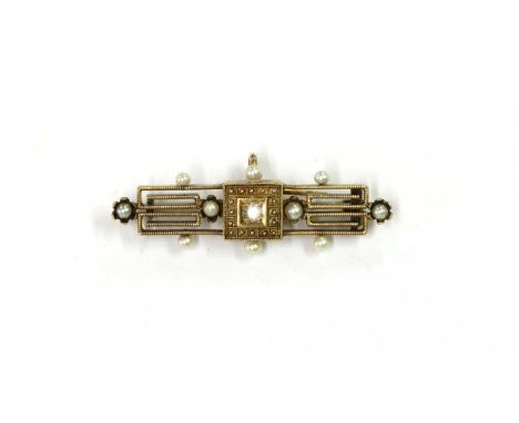 A gold Archaeological revival diamond and seed pearl brooch, an old European cut diamond grain set to a box collet at the cen
