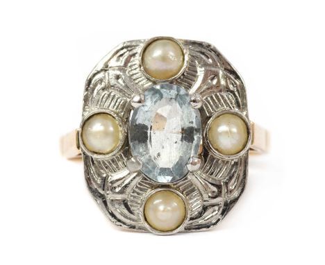 A gold aquamarine and split pearl ring, with an oval mixed cut aquamarine claw set to the centre, to quatrefoil surround of s