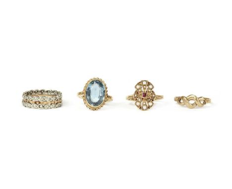 Four 9ct gold rings, to include a ruby and split pearl set fan shaped ring, London 1978, a single stone blue topaz ring, Birm