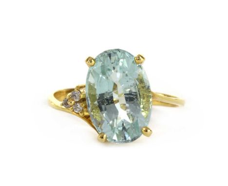 A gold aquamarine and diamond ring, with an oval mixed cut aquamarine, approximately 12 x 8mm, claw set, with a trefoil of br