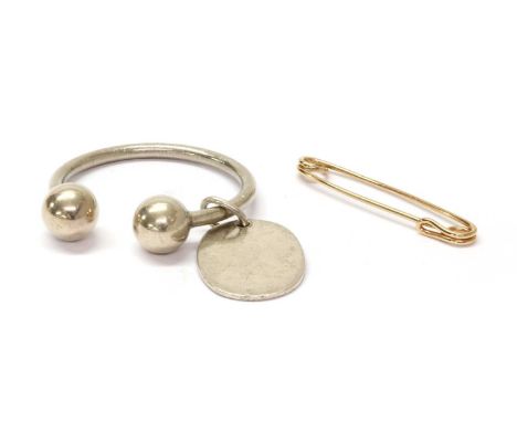 A sterling silver key ring, by Tiffany &amp; Co., of torque bangle form, with an oval disc, marked STERLING TIFFANY &amp; CO,