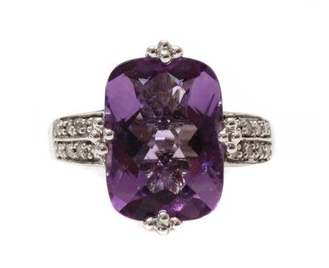 A white gold amethyst and diamond ring, with a cushion shaped amethyst with chequerboard cut crown, approximately 14 x 10mm, 