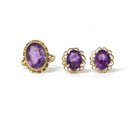 A 9ct gold single stone amethyst ring, with an oval mixed cut amethyst, approximately 14 x 10mm, rub set to a fluted border, 