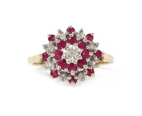 A 9ct gold diamond and ruby target cluster ring, with an eight cut diamond grain set to an illusion collet at the centre, to 