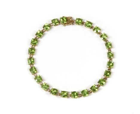 A gold peridot bracelet, with cushion shaped chequerboard cut peridots, claw set to articulated collets, with box clasp and t