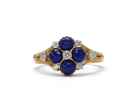 A 9ct gold diamond and lapis lazuli cluster ring, by Luke Stockley Jewellery, with a brilliant cut diamond claw set to the ce