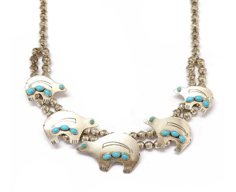 An American Southwest Indian silver and turquoise necklace, by Julius Hoskie, five graduated heartline or spirit bear symbols