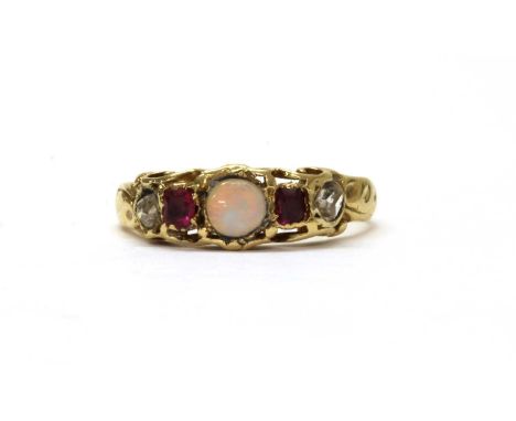 A gold opal, ruby and diamond ring, with a later replacement round cabochon opal at the centre, with an old cushion cut ruby 