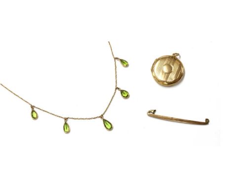 A gold peridot fringe necklace, with five graduated pear mixed cut peridots, spectacle set, to a trace link chain with bolt r