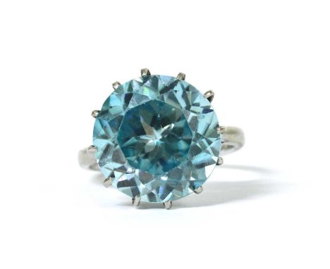 A white gold single stone blue zircon ring, the circular mixed cut blue zircon, approximately 12.5mm, claw set to a rex colle