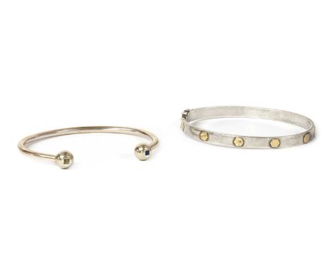 A gentlemen's silver and gold oval hinged bangle, the silver flat section bangle with applied gold hexagonal detail, to box c