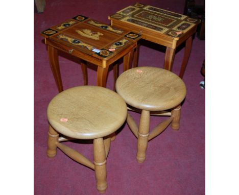 A continental hinge-top musical table; together with one other and a pair of contemporary light oak circular low milking stoo