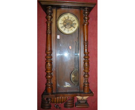 An early 20th century walnut cased Vienna drop trunk wall clock