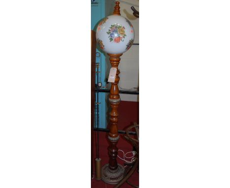 An Eastern hardwood and pierced metal mounted standard lamp, with integral floral decorated milk glass globular shade