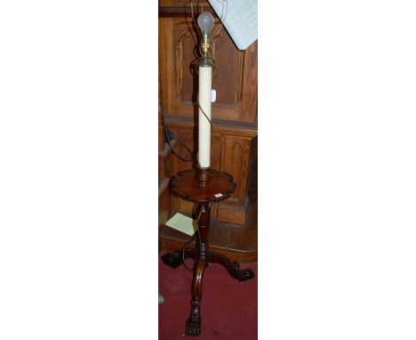 A mahogany lamp standard, in the style of a Georgian kettle stand, with carved lion paw feet, h.120cm (excluding fittings)