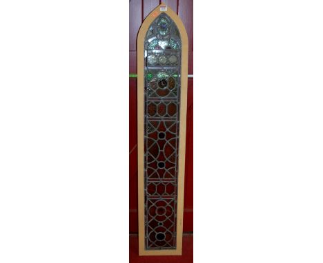 A coloured glass lead light, of arched lancet form, in modern frame

