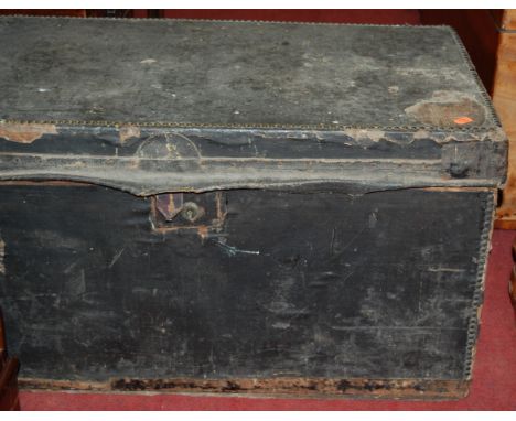 A canvas clad studded and metal bound hinge-top travelling trunk 
