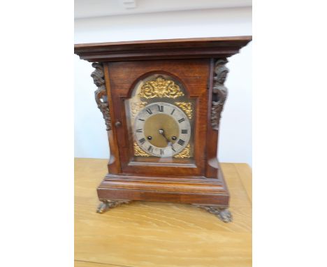 An 8 day bracket clock with a brass dial striking on a gong with pendulum and key - one hand missing 