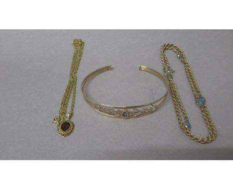 A 9ct hallmarked yellow gold chain with aquamarine, 45cm, with a 9ct yellow gold chain, 45cm with red garnet pendant and a 9c