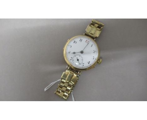 An 18ct vintage gents wristwatch with a gold plated strap with a seconds hand - in working order 