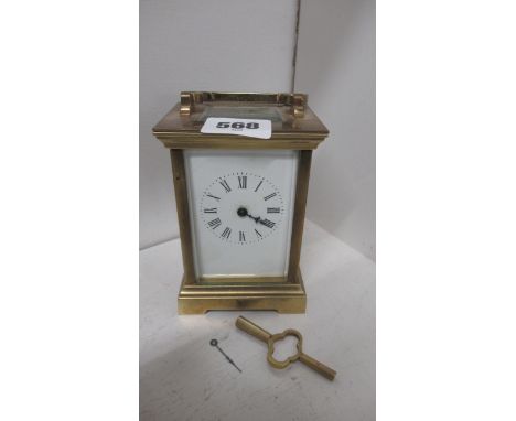 A 19th century carriage clock with key, hand detached but present 