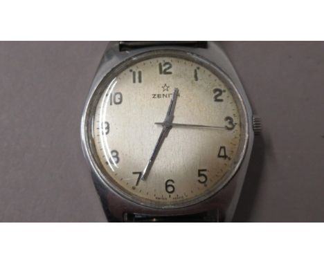 ZENITH. 50's/60's plain steel. 35mm. Arabic numerals. Manual nicely aged. Original button. Working in saleroom 