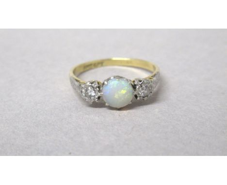 An 18ct and platinum hallmarked opal and diamond trilogy ring, size Q, approx 2.7 grams 