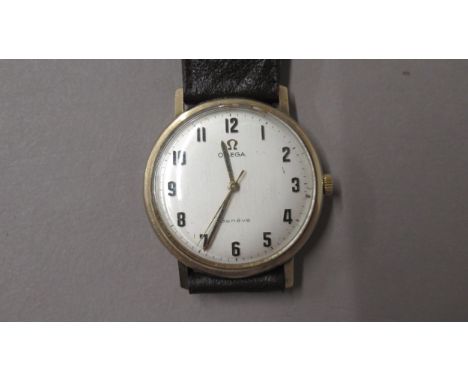 A gents 9ct gold cased Omega Geneve manual wind with Arabic numerals, wristwatch - case approx 35mm - needs attention, second