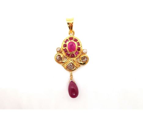 An Indian hi-grade gold (tested) pendant with rubies and diamonds - the central oval cut ruby surrounded by ten square cut ru