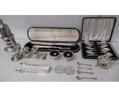 Assorted silver items including sugar sifter, pair of salts, three piece condiment set, set of six teaspoons, cigar clippers 
