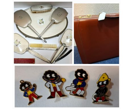 Two vintage dressing table sets, a late 20th Century Jacob tan leather briefcase, 3 Robinsons golly badges, a golly pendant a